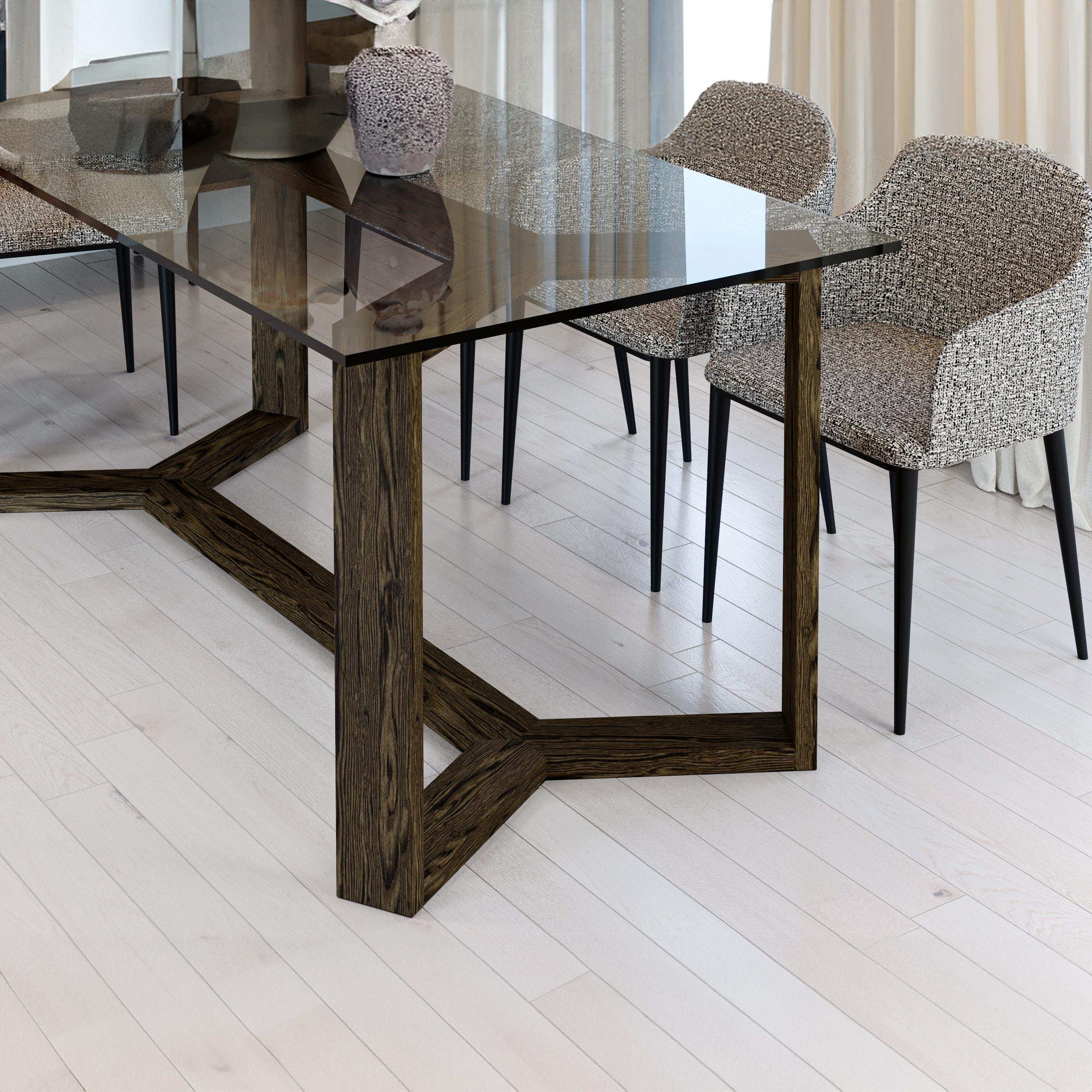 Dining table with glass top and wooden legs in a modern interior setting